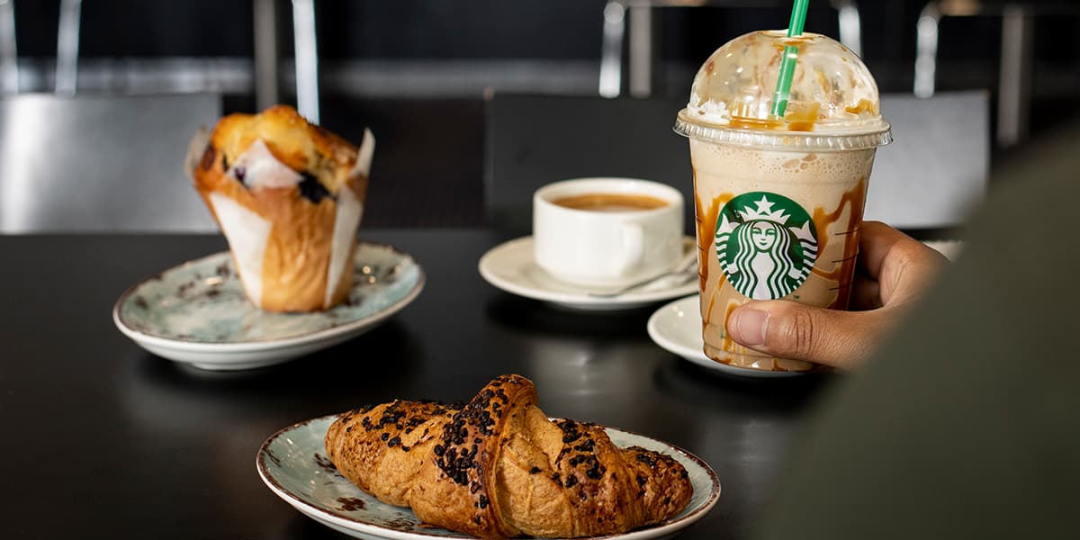 Croissant and Starbucks coffee in Coffee Crew onboard Newcastle-Amsterdam